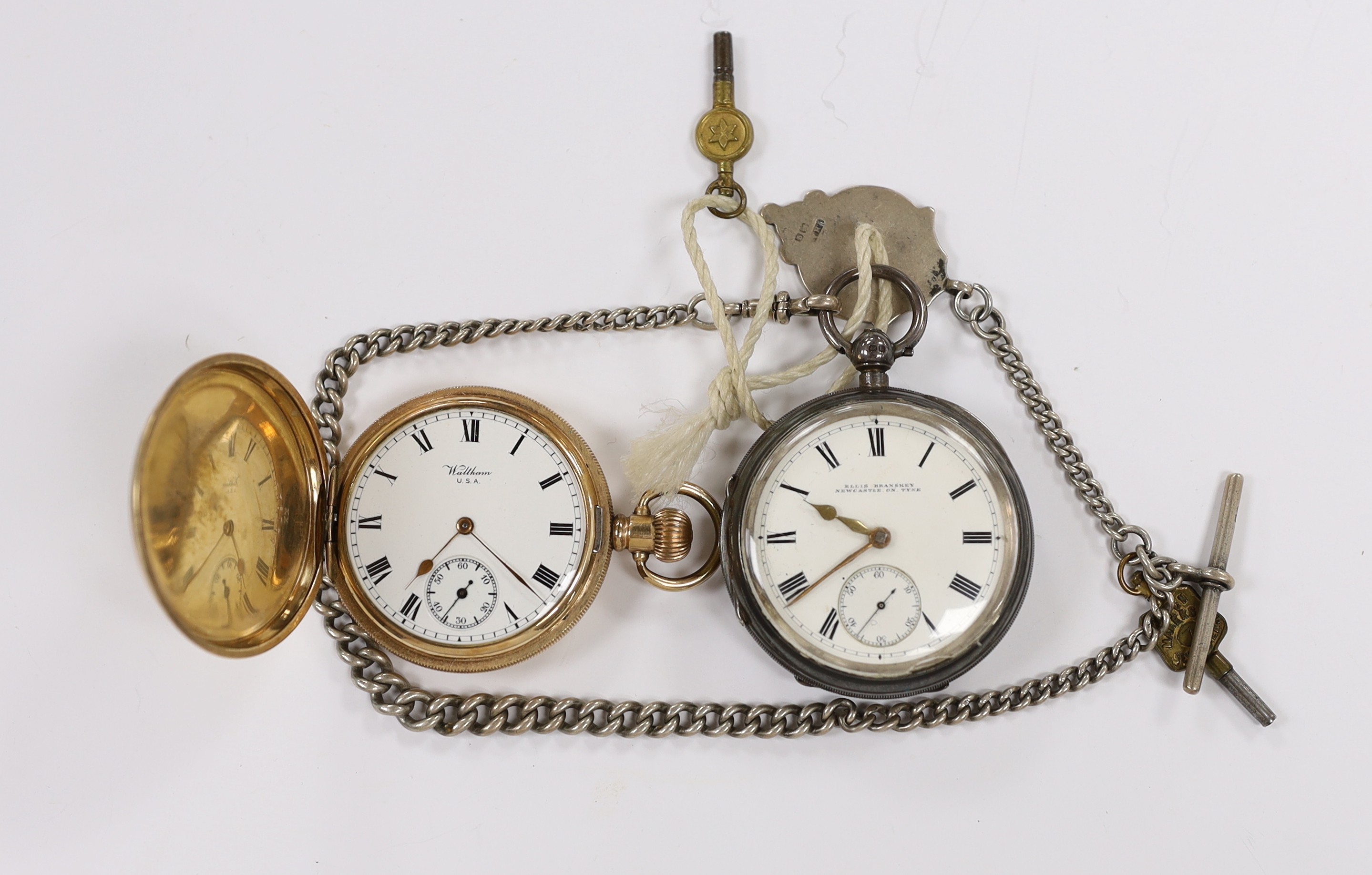 A George V silver open face keywind pocket watch by Ellis Branskey of Newcastle, on a graduated silver curb link albert, together with a gold plated Waltham hunter pocket watch and a Swiss 935 white metal half hunter fob